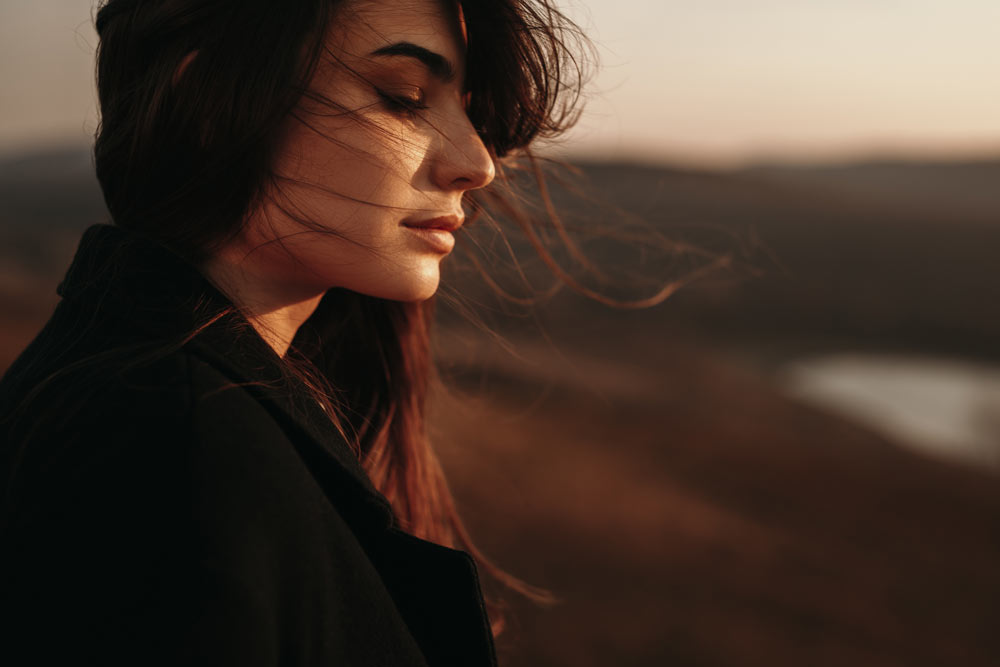 Young woman looking out into the landscape beyond