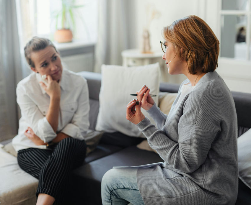 Woman listening to her counselor in a therapy session