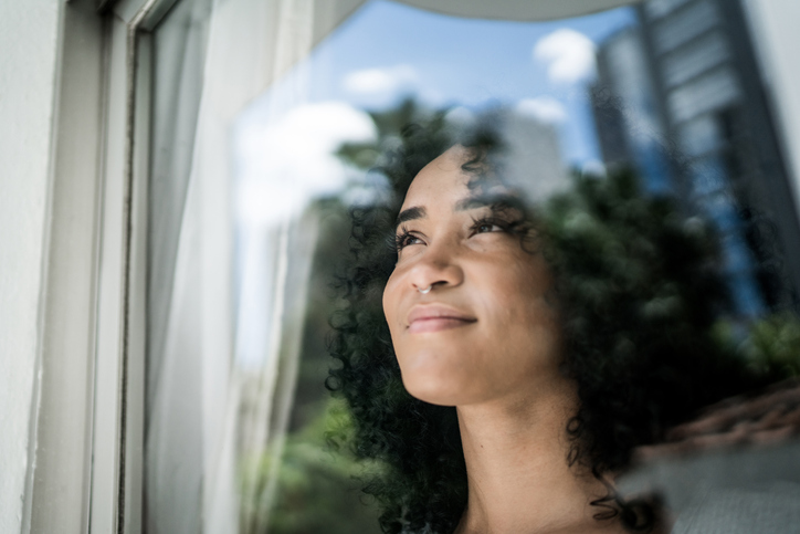 young woman looking out of a window