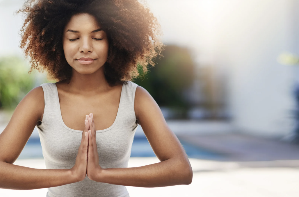 A woman meditating.